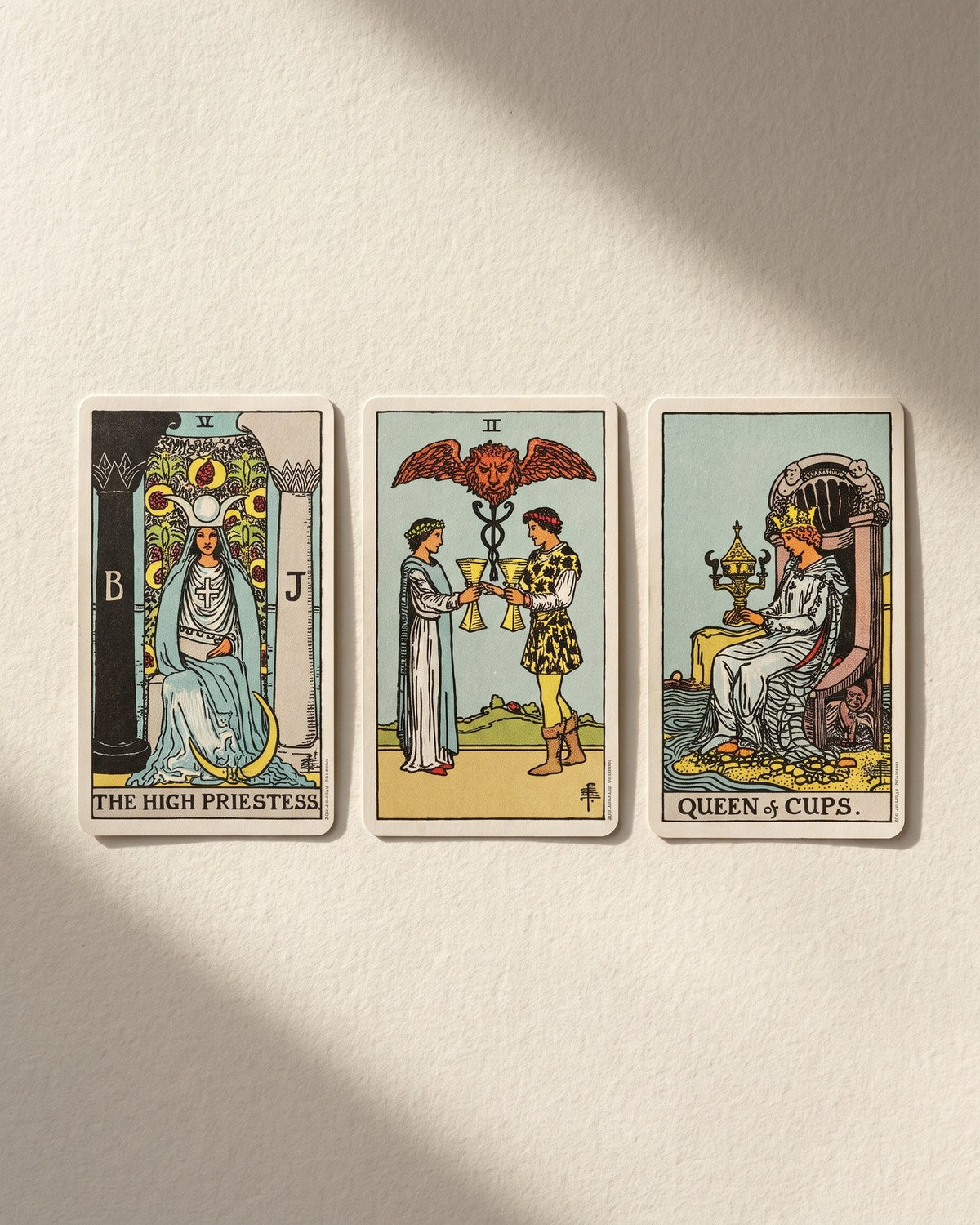 Three cards face up on cream paper